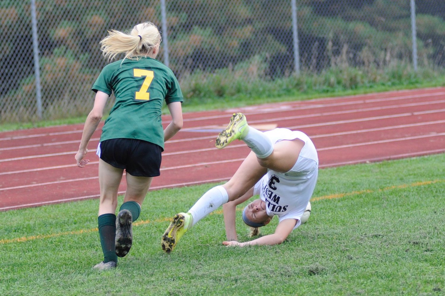 Head over heels about soccer. Sullivan West’s Abby Parucki takes a tumble going after the ball, as Eldred’s Jada Reed closes in on the action...